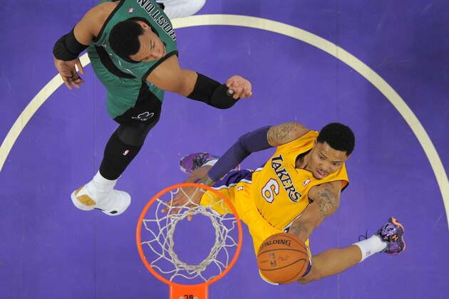 Los Angeles Lakers guard Kent Bazemore, right, goes up for a shot as Boston Celtics center Jared Sullinger defends during the first half of an NBA basketball game, Friday, Feb. 21, 2014, in Los Angeles. (AP Photo/Mark J. Terrill)