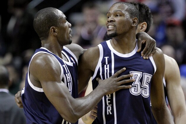 Oklahoma City Thunder center Serge Ibaka, left, walks teammate Kevin Durant away from the referee after Durant is called for a technical foul during the first half of an NBA basketball game against the Portland Trail Blazers in Portland, Ore., Tuesday, Feb. 11, 2014. (AP Photo/Don Ryan)