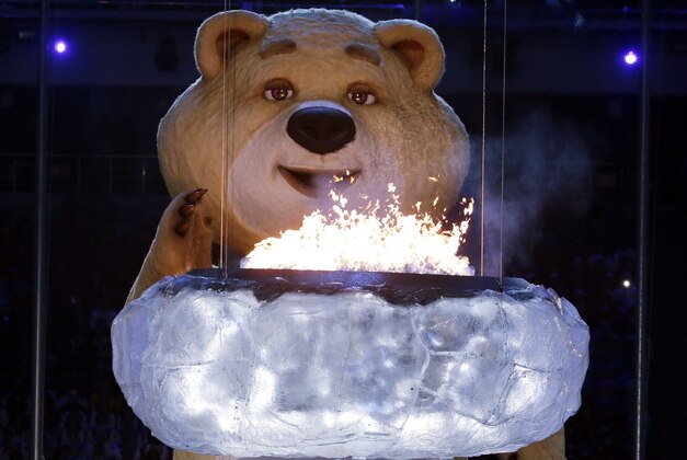 A large mascot blows out the Olympic flame with his breath during the closing ceremony of the 2014 Winter Olympics, Sunday, Feb. 23, 2014, in Sochi, Russia. (AP Photo/Charlie Riedel)