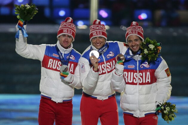 From left, Russia's silver medal winner Maxim Vylegzhanin, Russia's gold medal winner Alexander Legkov and Russia's bronze medal winner Ilia Chernousov pose during the medals ceremony for the men's 50K cross-country race during the closing ceremony of the 2014 Winter Olympics, Sunday, Feb. 23, 2014, in Sochi, Russia. (AP Photo/Charlie Riedel)