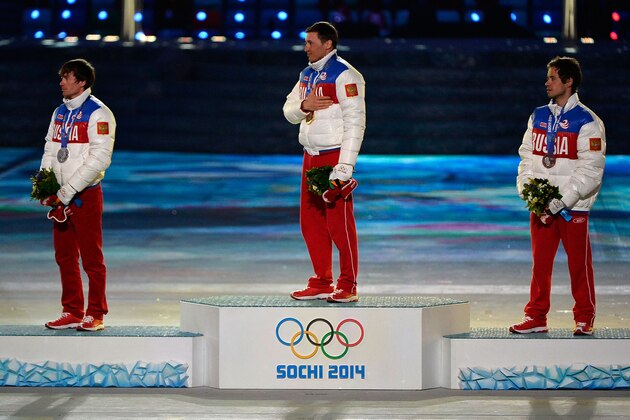 SOCHI, RUSSIA - FEBRUARY 23:  (L-R) Silver medalist Maxim Vylegzhanin of Russia, gold medalist Alexander Legkov of Russia and bronze medalist Ilia Chernousov of Russia celebrate during the medal ceremony for the Men's 50 km Mass Start Free during the 2014 Sochi Winter Olympics Closing Ceremony at Fisht Olympic Stadium on February 23, 2014 in Sochi, Russia.  (Photo by Pascal Le Segretain/Getty Images)