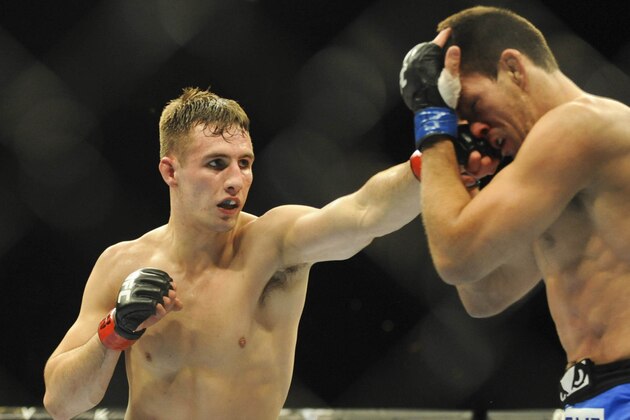 Feb 22, 2014; Las Vegas, NV, USA;  Rory MacDonald (red gloves) lands a punch on Demian Maia (blue gloves) during their UFC welterweight bout at Mandalay Bay. MacDonald won by way of a 29-28 decision. Mandatory Credit: Stephen R. Sylvanie-USA TODAY Sports
