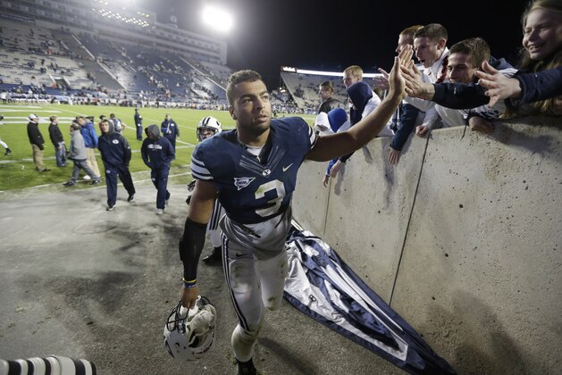 Brigham Young linebacker Kyle Van Noy (3) high fives Brigham Young fans as he walks off the field following their NCAA college football game against Middle Tennessee Friday, Sept. 27, 2013, in Provo, in Utah. Brigham Young  defeated Middle Tennessee 37-10.  (AP Photo/Rick Bowmer)
