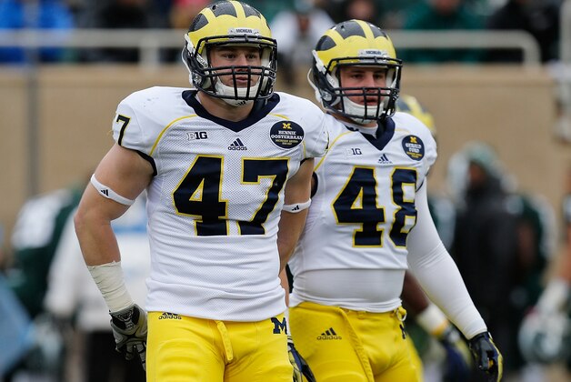 EAST LANSING, MI - NOVEMBER 02: Jake Ryan #47 and Desmond Morgan #48 of the Michigan Wolverines take a break in between plays against the Michigan State Spartans at Spartan Stadium on November 2, 2013 in East Lansing, Michigan. (Photo by Gregory Shamus/Getty Images)