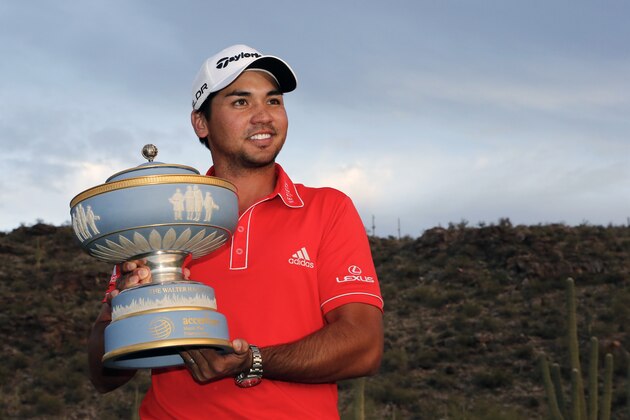Jason Day, of Australia, poses with the trophy after winning his championship match against Victor Dubuisson, of France, during the Match Play Championship golf tournament on Sunday, Feb. 23, 2014, in Marana, Ariz. (AP Photo/Matt York)