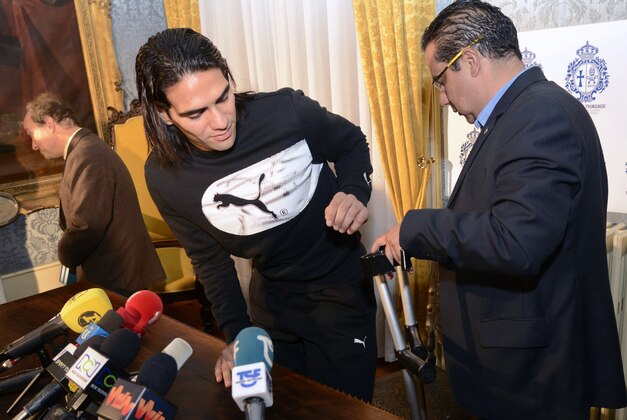 Colombian soccer star Radamel Falcao is helped with his crutches by Doctor Carlos Ulloa, right, also from Colombia after a press conference at the Trindade Hospital in Porto, Portugal, Monday, Jan. 27, 2014. Colombia and Monaco's striker Falcao is in a race against time to get fit for the World Cup in June after undergoing knee surgery Saturday, Jan. 25, with his doctor giving him a better than 50-50 chance of making it. (AP Photo/Paulo Duarte)
