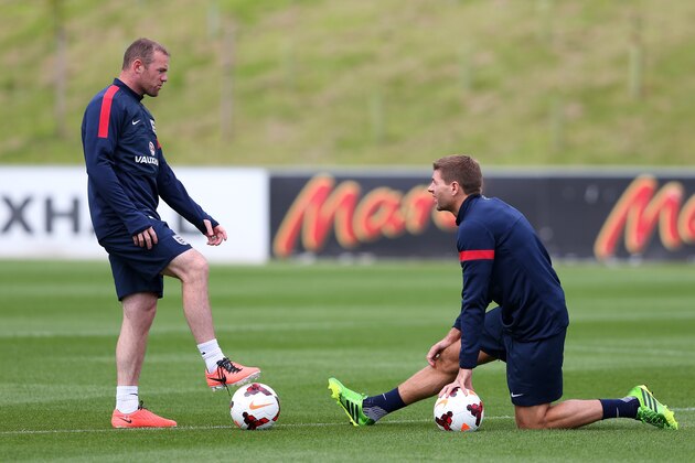 BURTON-UPON-TRENT, ENGLAND - AUGUST 12:  Wayne Rooney of England talks with Steven Gerrard during a training session at St Georges Park on August 12, 2013 in Burton-upon-Trent, England.  (Photo by Alex Livesey/Getty Images)