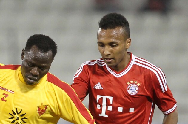 Bayern Munich's Julian Green, right, of Munich and Balla Jabir of Al-Merrikh, challenge for the ball,  during their friendly soccer match, at Al-Saad stadium in Doha Thursday, Jan. 9, 2014. (AP Photo/Osama Faisal)