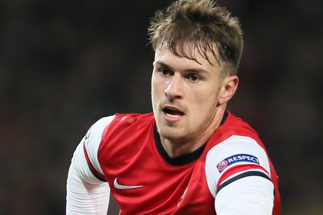 Arsenal's Aaron Ramsey runs after the ball during the Group F Champions League soccer match between Arsenal and Marseille at the Emirates stadium in London, Tuesday, Nov. 26, 2013. (AP Photo/Alastair Grant)