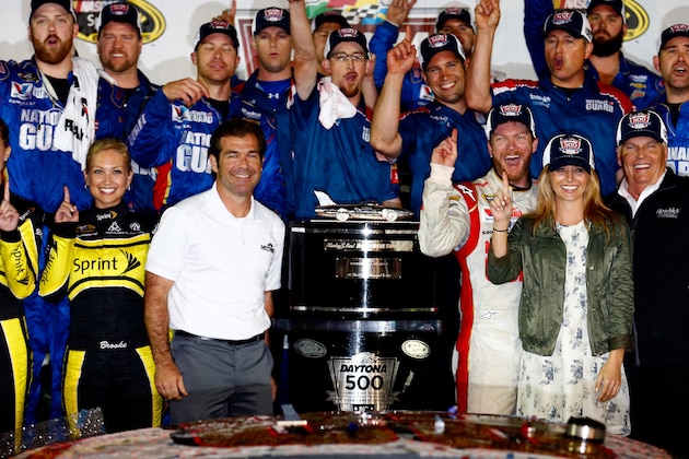 DAYTONA BEACH, FL - FEBRUARY 23:  Dale Earnhardt Jr., driver of the #88 National Guard Chevrolet, celebrates in Victory Lane with his girlfriend Amy Reimann, team owner Rick Hendrick and  Joie Chitwood III after winning during the NASCAR Sprint Cup Series Daytona 500 at Daytona International Speedway on February 23, 2014 in Daytona Beach, Florida.  (Photo by Tom Pennington/Getty Images)