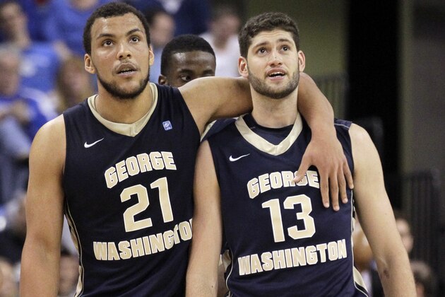George Washington's Kevin Larsen, left, and teammate Patricio Garino pause during the second half of an NCAA college basketball game against Saint Louis Saturday, Feb. 22, 2014, in St. Louis. Saint Louis won 66-59. (AP Photo/Whitney Curtis)