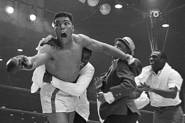 Cassius Clay's handlers hold him back as he reacts after he is announced the new heavyweight champion of the world on a seventh round technical knockout against Sonny Liston at Convention Hall in Miami Beach, Fla., on Feb. 25, 1964. (AP Photo) Cassius Clay's handlers hold him back as he reacts after he is announced the new heavyweight champion of the world on a seventh round technical knockout against Sonny Liston at Convention Hall in Miami Beach, Fla., on Feb. 25, 1964. (AP Photo)