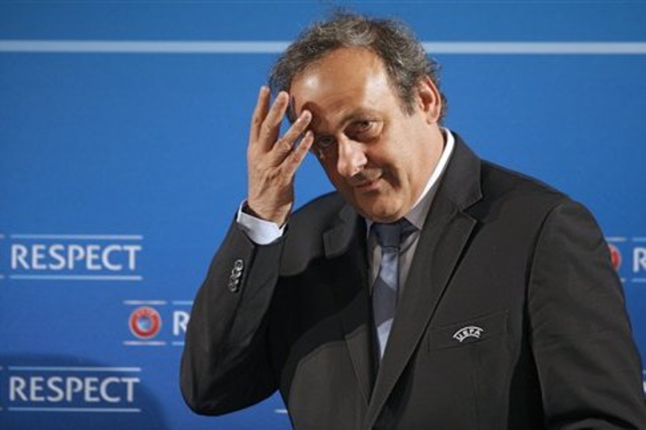 UEFA President Michel Platini gestures, prior to a press conference, one day prior to the Euro 2016 qualifying draw, at the Acropolis Convention Centre, in Nice, southeastern France, Saturday, Feb 22, 2014. (AP Photo/Lionel Cironneau)