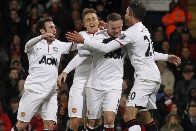 Manchester United's Wayne Rooney, second right, celebrates his goal against Crystal Palace with teammates during their English Premier League soccer match at Selhurst Park, London, Saturday, Feb. 22, 2014. (AP Photo/Sang Tan)