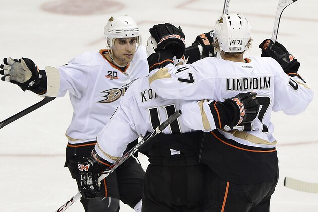 Anaheim Ducks center Andrew Cogliano, left, celebrates with Saku Koivu (11), of Finland, and Hampus Lindholm (47), of Sweden, after Lindholm scored a goal in the third period of an NHL hockey game against the Nashville Predators on Saturday, Feb. 8, 2014, in Nashville, Tenn. The Ducks won 5-2. (AP Photo/Mark Zaleski)