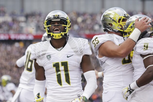 Oregon's Bralon Addison (11) reacts after a team touchdown against Washington in the first half of an NCAA college football game, Saturday, Oct. 12, 2013, in Seattle. (AP Photo/Elaine Thompson)