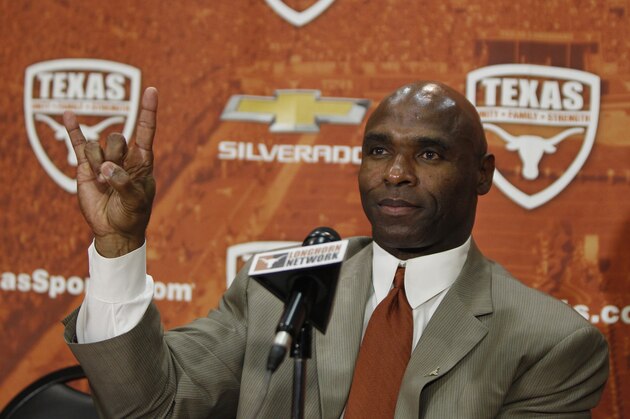 AUSTIN, TX - JANUARY 6: The University of Texas Longhorns new head football coach Charlie Strong from Louisville flashes the 'Hook 'Em Horns' sign after being introduced during a press conference January 6, 2014 at Darrell K. Royal-Texas Memorial Stadium in Austin, Texas.  (Photo by Erich Schlegel/Getty Images)
