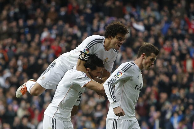 Real's Gareth Bale, right, celebrates his goal with teammates during a Spanish La Liga soccer match between Real Madrid and Elche at the Santiago Bernabeu stadium in Madrid, Spain, Saturday, Feb. 22, 2014. (AP Photo/Andres Kudacki)