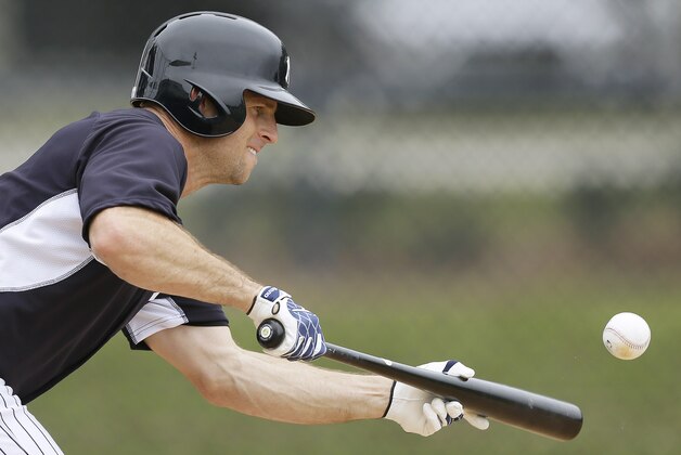 New York Yankees center fielder Brett Gardner bunts during spring training baseball practice Friday, Feb. 21, 2014, in Tampa, Fla. (AP Photo/Charlie Neibergall)