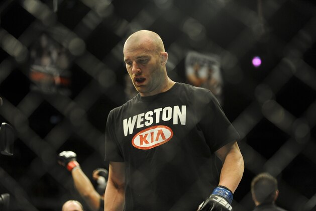 Feb 22, 2014; Las Vegas, NV, USA; Patrick Cummins walks out of the octagon after being defeated by  Daniel Cormier (red gloves) after their UFC light heavyweight bout at Mandalay Bay. Cormier won by way of a TKO in the first round. Mandatory Credit: Stephen R. Sylvanie-USA TODAY Sports