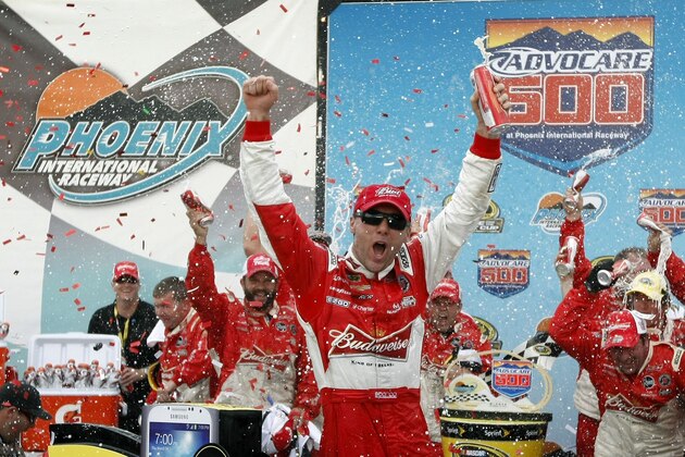 Kevin Harvick, center, celebrates in victory lane after winning the AdvoCare 500 NASCAR Sprint Cup Series auto race at Phoenix International Raceway, Sunday, Nov. 10, 2013, in Avondale, Ariz. (AP Photo/Ralph Freso)