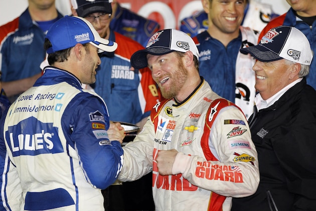 Dale Earnhardt Jr., center, celebrates in Victory Lane with teammate Jimmie Johnson, left, and team owner Rick Hendrick, right, after winning the NASCAR Daytona 500 Sprint Cup series auto race at Daytona International Speedway in Daytona Beach, Fla., Sunday, Feb. 23, 2014. (AP Photo/Terry Renna)