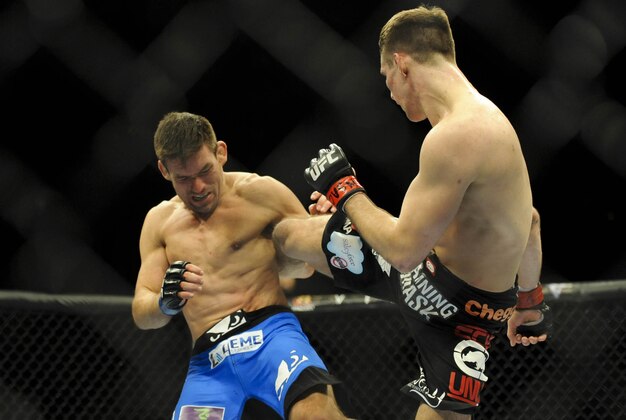 Feb 22, 2014; Las Vegas, NV, USA;  Rory MacDonald (red gloves) lands a kick on Demian Maia (blue gloves) during their UFC welterweight bout at Mandalay Bay. MacDonald won by way of a 29-28 decision. Mandatory Credit: Stephen R. Sylvanie-USA TODAY Sports