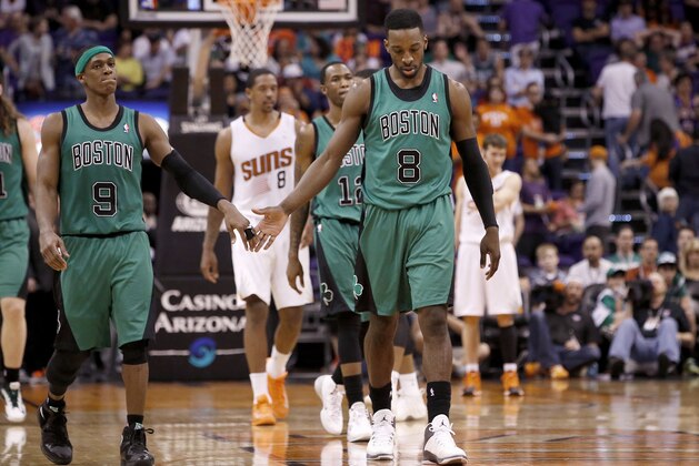 Boston Celtics' Rajon Rondo (9) and Jeff Green (8) dejectedly slap hands after the Celtics failed to score against the Phoenix Suns in the closing moments during the second half of an NBA basketball game, Wednesday, Feb. 19, 2014, in Phoenix.  The Suns defeated the Celtics 100-94. (AP Photo/Ross D. Franklin)