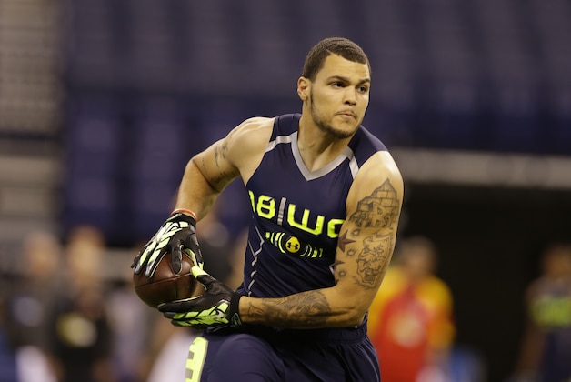 Texas A&M wide receiver Mike Evans makes a catch during a drill at the NFL football scouting combine in Indianapolis, Sunday, Feb. 23, 2014. (AP Photo/Michael Conroy)
