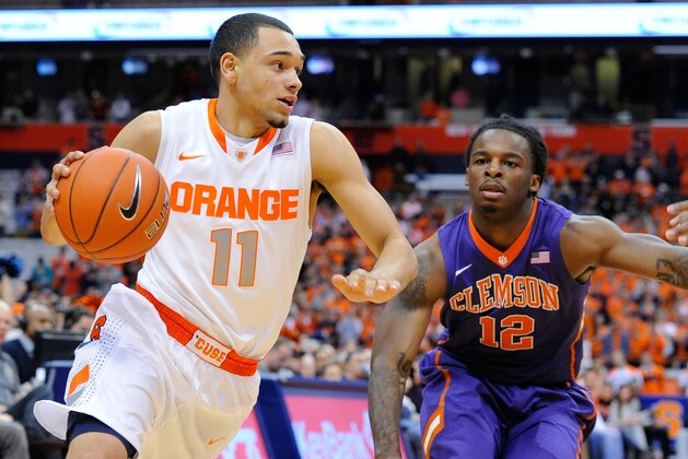 Feb 9, 2014; Syracuse, NY, USA; Syracuse Orange guard Tyler Ennis (11) dribbles the ball in front of Clemson Tigers guard Rod Hall (12) during the first half at the Carrier Dome.  Mandatory Credit: Rich Barnes-USA TODAY Sports