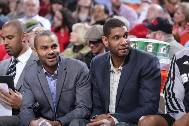 PORTLAND, OR - FEBRUARY 19:  Tony Parker #9 and Tim Duncan #21 of the San Antonio Spurs talk on the bench against the Portland Trail Blazers on February 19, 2014 at the Moda Center Arena in Portland, Oregon. NOTE TO USER: User expressly acknowledges and agrees that, by downloading and or using this photograph, user is consenting to the terms and conditions of the Getty Images License Agreement. Mandatory Copyright Notice: Copyright 2014 NBAE (Photo by Sam Forencich/NBAE via Getty Images)