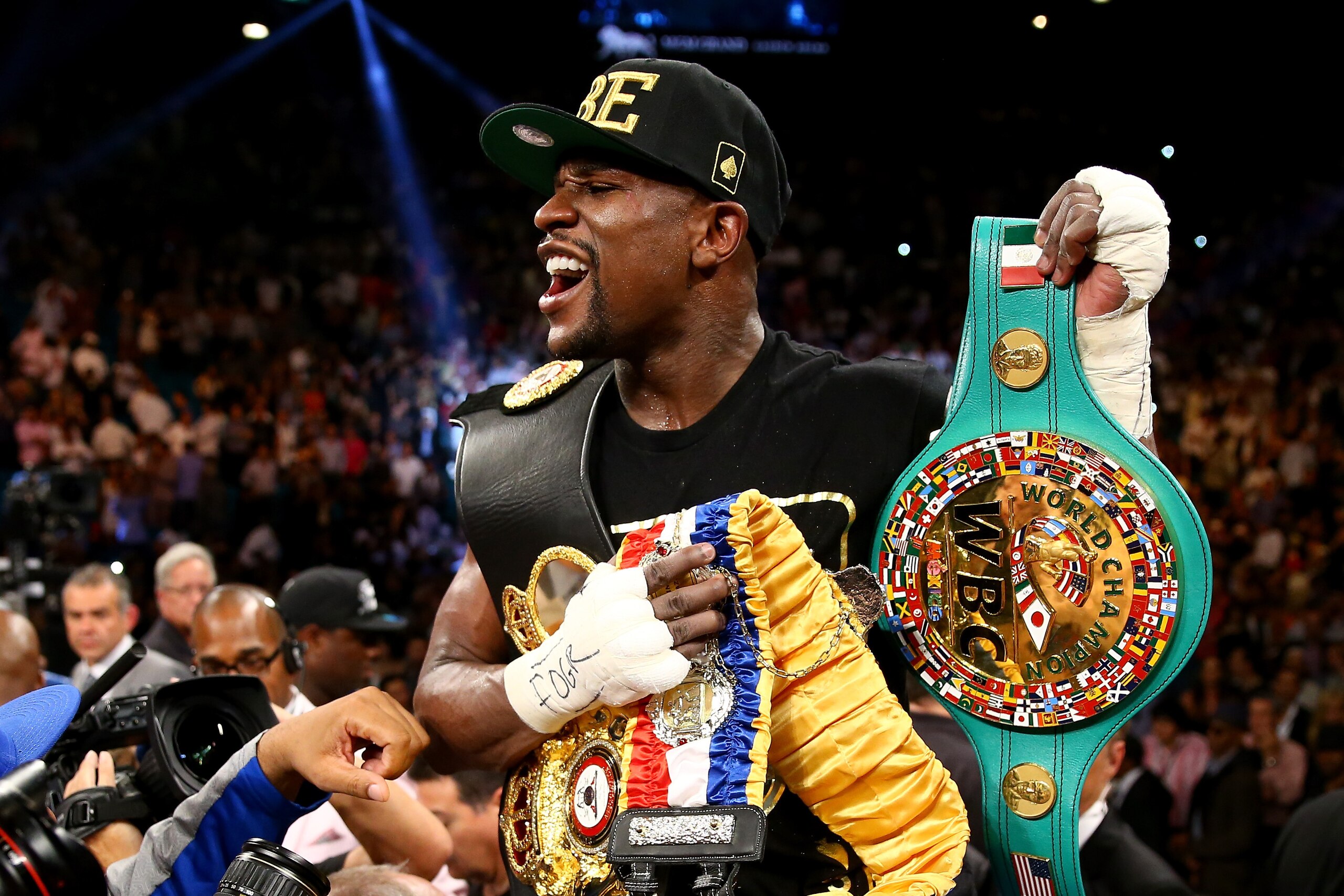 LAS VEGAS, NV - SEPTEMBER 14:  Floyd Mayweather Jr. celebrates his majority decision victory against Canelo Alvarez in their WBC/WBA 154-pound title fight at the MGM Grand Garden Arena on September 14, 2013 in Las Vegas, Nevada.  (Photo by Al Bello/Getty Images)