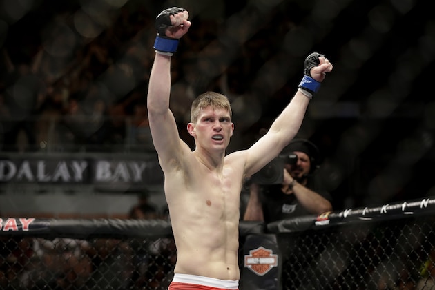 Stephen Thompson celebrates his TKO win over Robert Whittaker following a UFC 170 mixed martial arts welterweight fight on Saturday, Feb. 22, 2014, in Las Vegas. (AP Photo/Isaac Brekken)