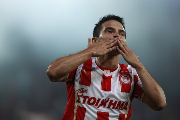Javier Saviola  celebrates his first goal with Olympiakos, against Atromitos  during a Greek league soccer match at the Karaiskaki stadium in the port of Piraeus, near Athens, Sunday, Aug. 25, 2013. Javier Saviola scored the winner with a header in the 54th minute to give Olympiakos a 2-1 victory over visiting Atromitos in the Greek league. (AP Photo/Kostas Tsironis)