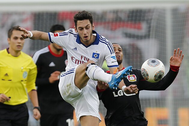 Hamburg's Hakan Calhanoglu of Turkey, left, and Leverkusen's Sidney Sam challenge for the ball during the German first division Bundesliga soccer match between Bayer Leverkusen and Hamburg SV in Leverkusen, Germany, Saturday, Nov. 9, 2013. (AP Photo/Frank Augstein)