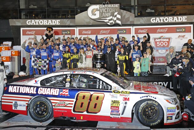 Dale Earnhardt Jr. celebrates with his crew in Victory Lane after winning the NASCAR Daytona 500 Sprint Cup series auto race at Daytona International Speedway in Daytona Beach, Fla., Sunday, Feb. 23, 2014. (AP Photo/Terry Renna)