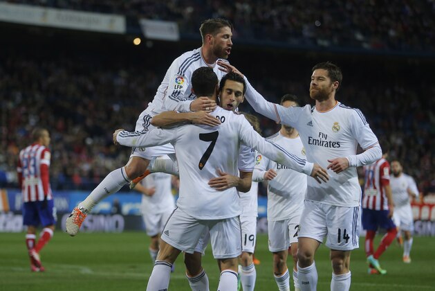 Real's Cristiano Ronaldo, center no. 7, celebrates his goal with teammates during a semifinal, 2nd leg, Copa del Rey soccer match between Atletico de Madrid and Real Madrid at the Vicente Calderon stadium in Madrid, Spain, Tuesday Feb. 11, 2014. (AP Photo/Andres Kudacki)
