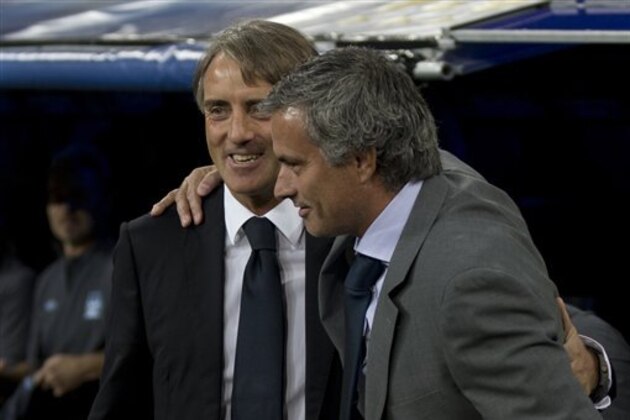 Manchester City's coach Roberto Mancini of Italy is embraced by Real Madrid coach Jose Mourinho from Portugal before a Champions League Group D soccer match at the Santiago Bernabeu Stadium, in Madrid, Tuesday, Sept. 18, 2012. (AP Photo/Daniel Ochoa De Olza)