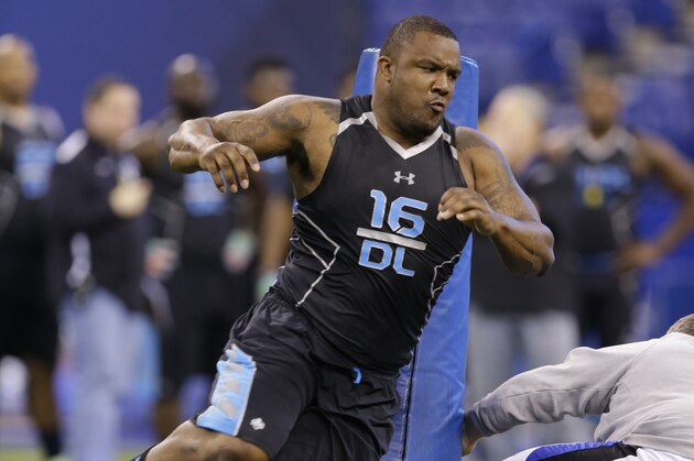 Minnesota defensive lineman Ra'Shede Hageman runs a drill at the NFL football scouting combine in Indianapolis, Monday, Feb. 24, 2014. (AP Photo/Michael Conroy)