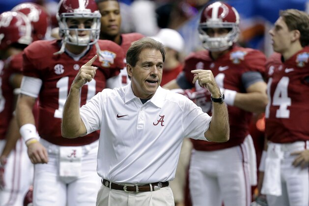 FILE - In this file photo from Jan. 2, 2014, Alabama head coach Nick Saban, center, calls drills as his team warms up before the NCAA college football Sugar Bowl against Oklahoma in New Orleans. The Southeastern Conference is still reigning supreme on the recruiting trail. The Crimson Tide is poised to bring in another top-rated recruiting class on Wednesday's, Feb. 5, 2014, national signing day. Six SEC rivals also have built top 10 classes, according to the 247Sports composite rankings of the major recruiting sites. (AP Photo/Rusty Costanza, File)