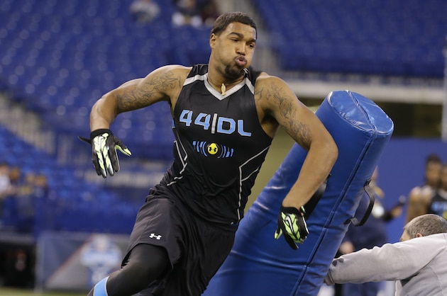 Louisville defensive lineman Marcus Smith runs a drill at the NFL football scouting combine in Indianapolis, Monday, Feb. 24, 2014. (AP Photo/Michael Conroy)