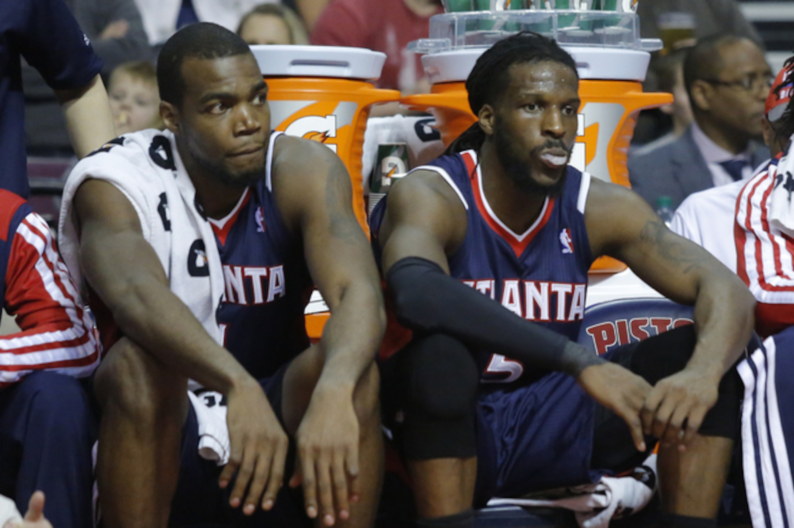 Atlanta Hawks forwards Paul Millsap, left, and DeMarre Carroll (5) sit on the bench during the second half of a 115-107 loss to the Detroit Pistons in an NBA basketball game Friday, Feb. 21, 2014, in Auburn Hills, Mich. (AP Photo/Duane Burleson)