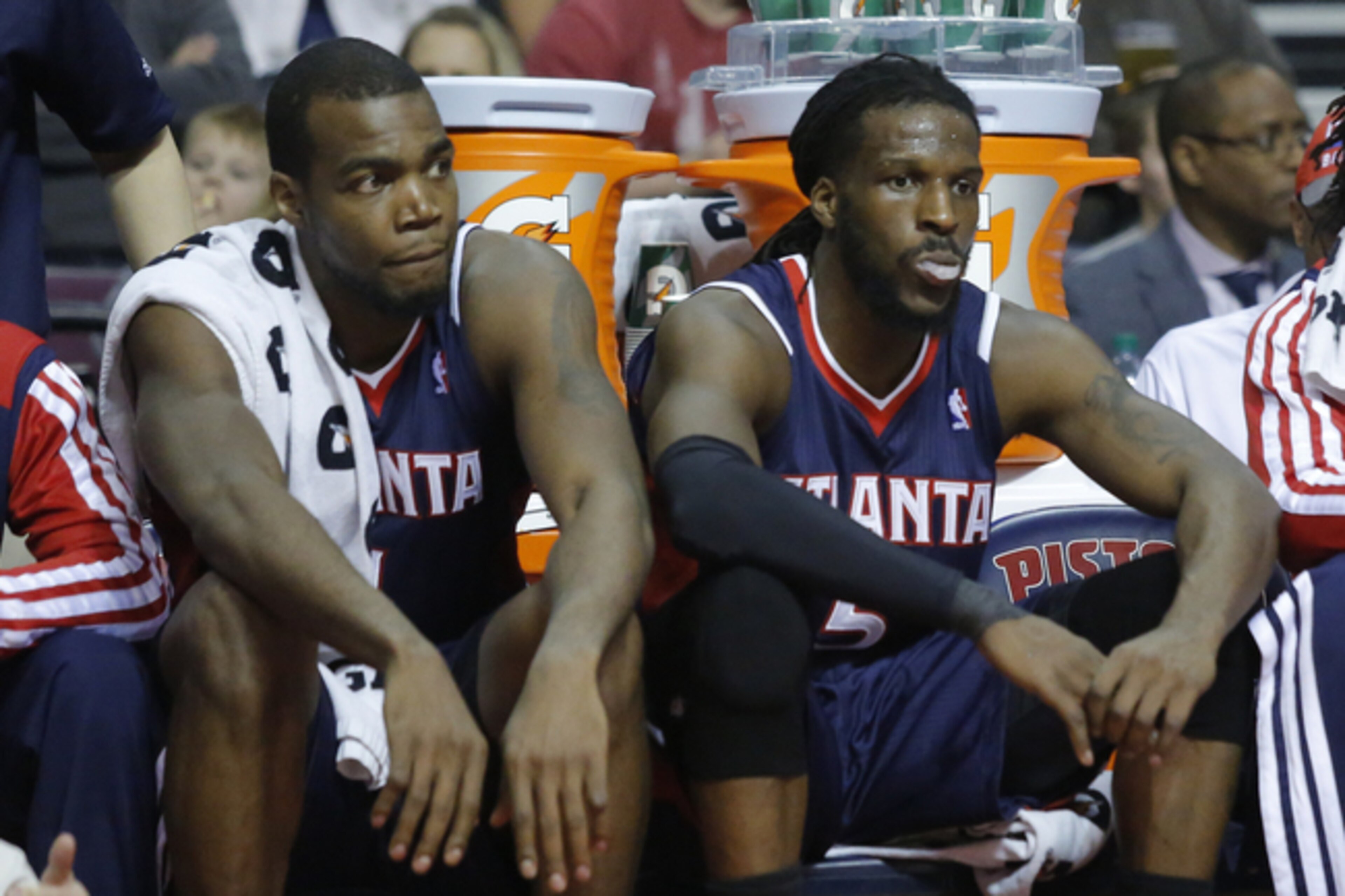 Atlanta Hawks forwards Paul Millsap, left, and DeMarre Carroll (5) sit on the bench during the second half of a 115-107 loss to the Detroit Pistons in an NBA basketball game Friday, Feb. 21, 2014, in Auburn Hills, Mich. (AP Photo/Duane Burleson)