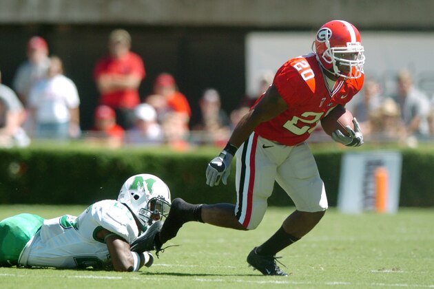 Georgia's Thomas Brown (20) loses his shoe while eluding a tackle by Marshall's Curtis Keyes during the the first half, Saturday, Sept. 18, 2004, at Sanford Stadium in Athens, Ga. (AP Photo/Rob Carr)