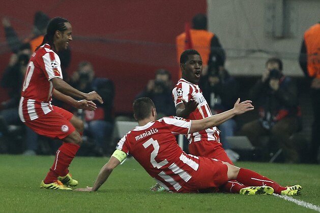 Olympiakos' Joel Campbell, right, celebrates his goal with teammates against Manchester United' during a Champions League, round of 16, first leg soccer match at Georgios Karaiskakis stadium, in Piraeus port, near Athens, on Tuesday, Feb. 25, 2014. (AP Photo/Petros Giannakouris)