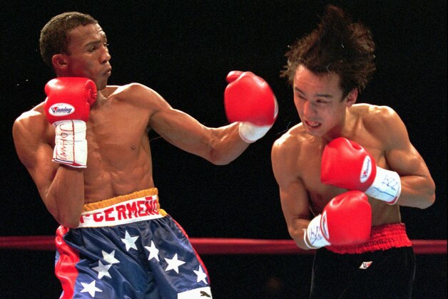 Antonio Cermeno of Venezuela, left, follows through with a punch to challenger Yuichi Kasai of Tokyo during the 10th round of their WBA Junior Featherweight Championship bout in Las Vegas Saturday, Dec. 21,1996. Cermeno retained his belt with a 12-round decision. (AP Photo/Jim Laurie)