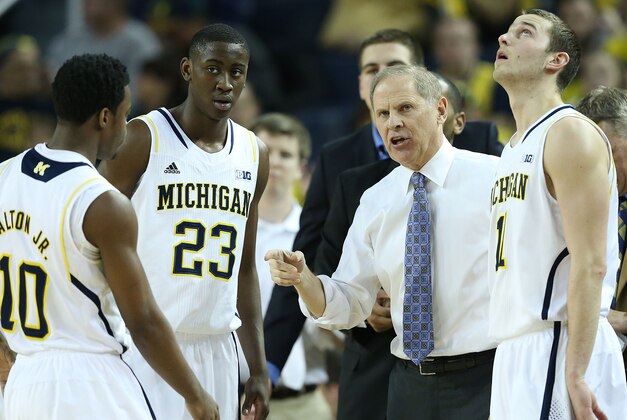 ANN ARBOR, MI - FEBRUARY 05: University of Michigan head coach John Beilein talks with Derrick Walton Jr #10 Caris LeVert #23 and Nik Stauskas #11 during the first half of the game against the Nebraska Cornhuskers at Crisler Arena on February 5, 2014 in Ann Arbor, Michigan. The Wolverines defeated the Cornhuskers 79-50. (Photo by Leon Halip/Getty Images)