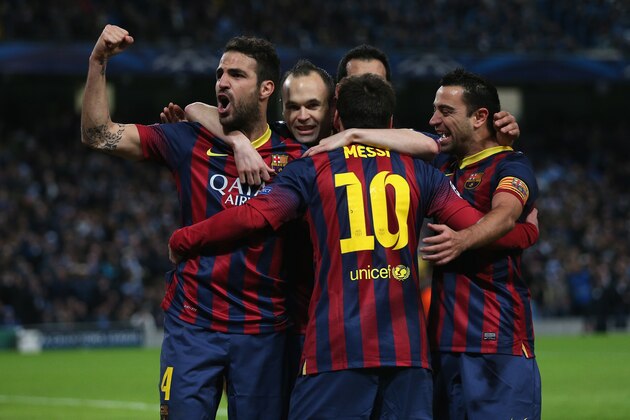 MANCHESTER, ENGLAND - FEBRUARY 18:  Lionel Messi of Barcelona celebrates scoring the opening goal from a penalty kick with his team-mates during the UEFA Champions League Round of 16 first leg match between Manchester City and Barcelona at the Etihad Stadium on February 18, 2014 in Manchester, England.  (Photo by Clive Brunskill/Getty Images)