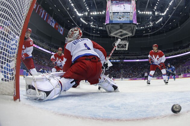The puck, shot by Finland forward Mikael Grandlund gets past Russia goaltender Semyon Varlamov for a goal in the second period of a men's ice hockey game at the 2014 Winter Olympics, Wednesday, Feb. 19, 2014, in Sochi, Russia. Finland won 3-1. (AP Photo/Julio Cortez, Pool) The puck, shot by Finland forward Mikael Grandlund gets past Russia goaltender Semyon Varlamov for a goal in the second period of a men's ice hockey game at the 2014 Winter Olympics, Wednesday, Feb. 19, 2014, in Sochi, Russia. Finland won 3-1. (AP Photo/Julio Cortez, Pool)