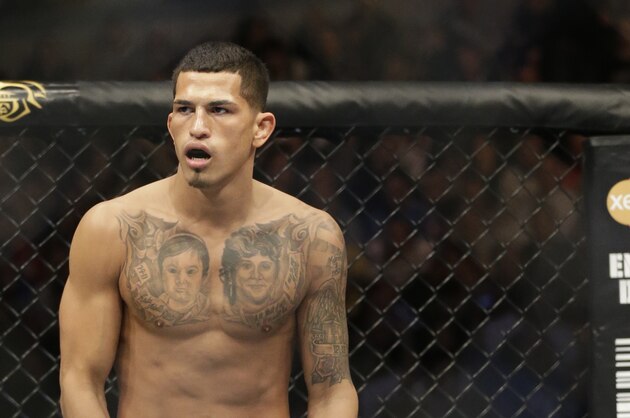 Anthony Pettis runs on the ring before fighting with Donald Cerrone during UFC Lightweight Championship on FOX 6 at the United Center in Chicago, Saturday, Jan. 26, 2013. Pettis won the bout. (AP Photo/Nam Y. Huh)
